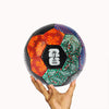 Colorful soccer ball with FIFA logo held by a hand on a white background