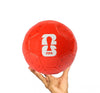 Red soccer ball with FIFA logo held by a hand on a white background